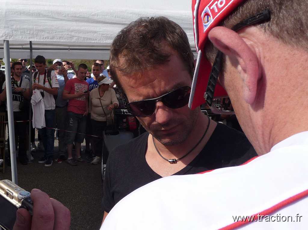 2012_Adr (74).jpg - 09/06/2012 - 68127 BILTZHEIM - L'ANNEAU DU RHIN - Journée d'ouverture du 10ème Festival Auto Moto en présence de Sébastien LOEB - Sébastien LOEB arrive mais continue les autographes au passage